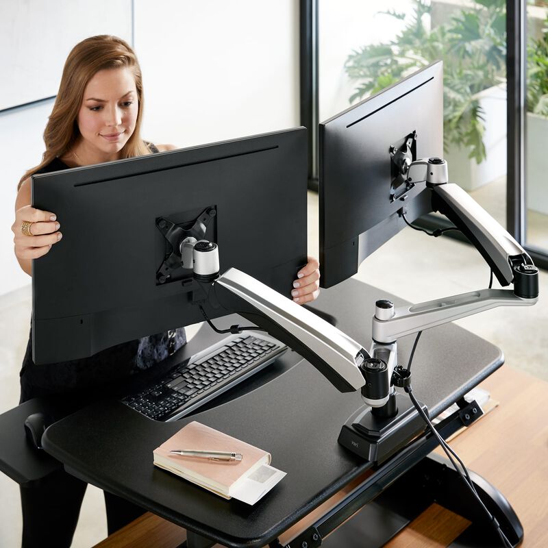 Woman adjusting Dual-Monitor Arm stand image number null