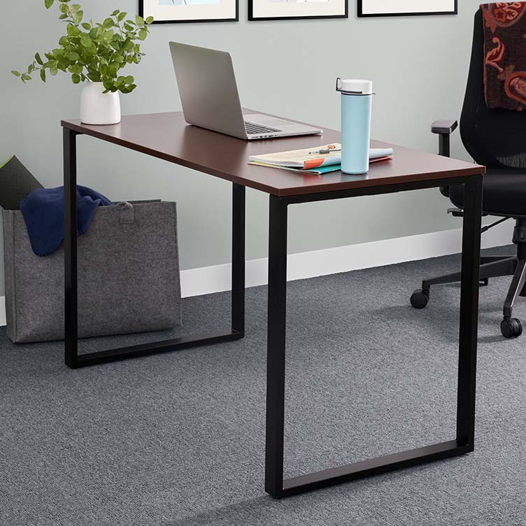 professional works in office setting with privacy panels to increase distance