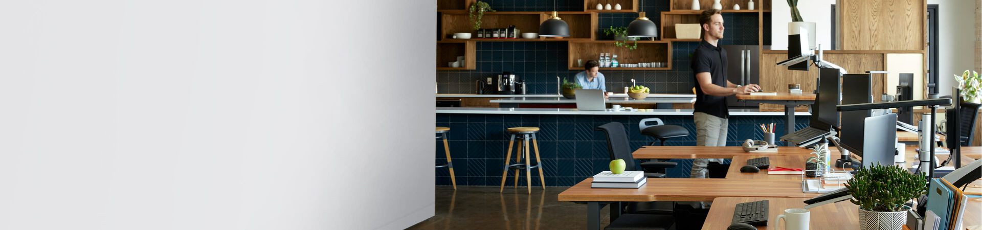 standing desks, office chairs, and other office furniture in an open workspace