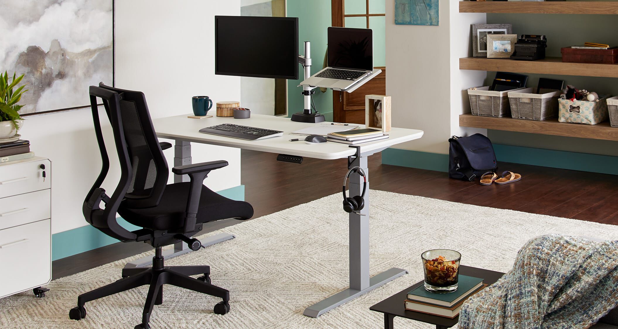 Electric standing desk in living room space to create a home office