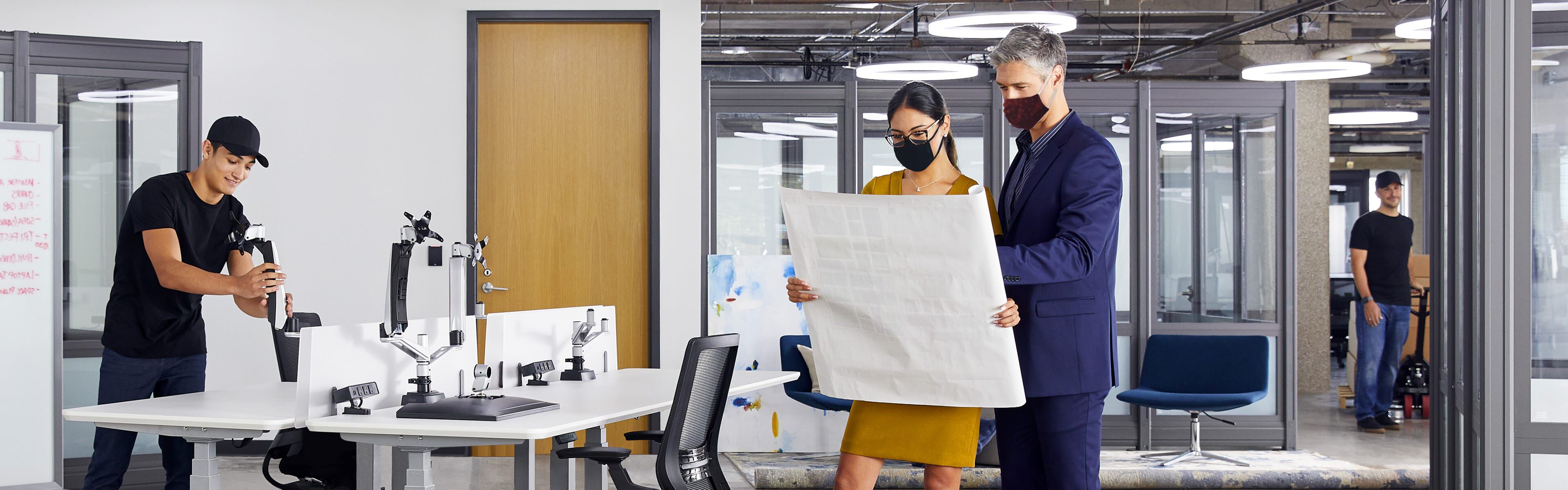 people reviewing a space plan in an office undergoing a furniture design project